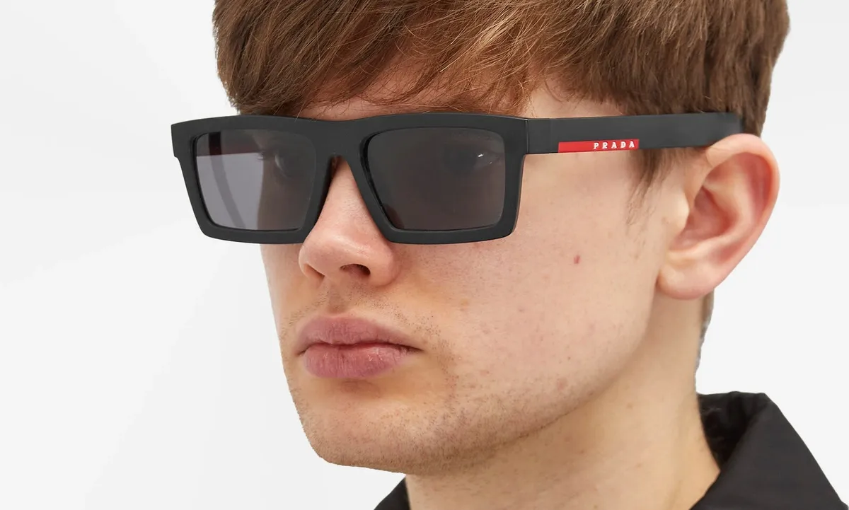A model wearing Prada Linea Rossa sunglasses
